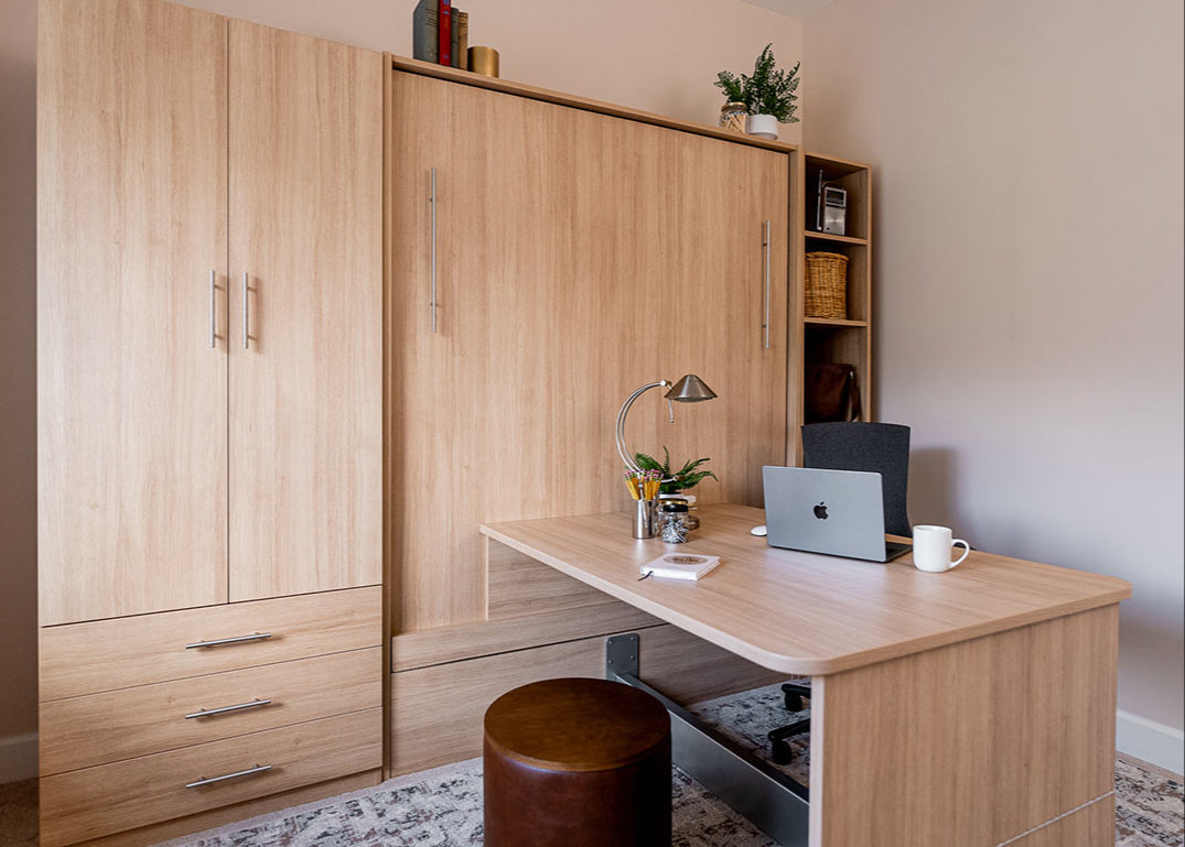 office scene showing a wall bed with table and matching cabinets