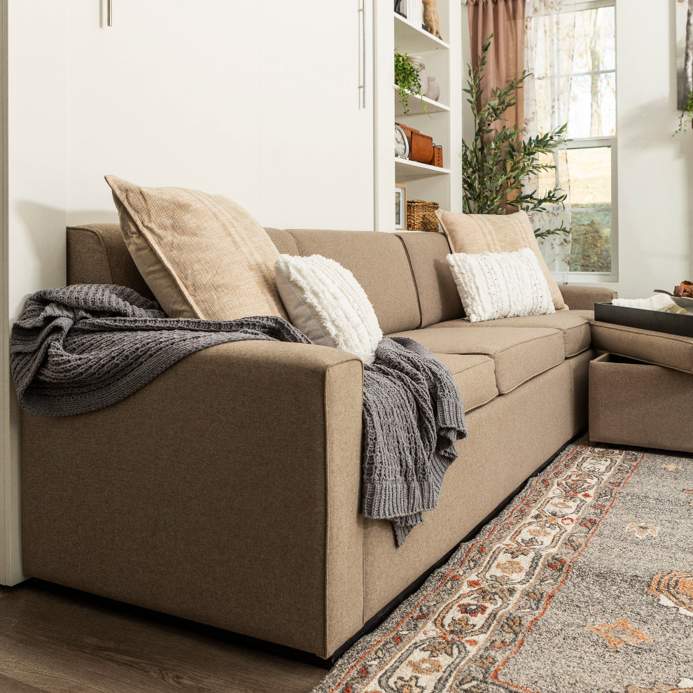View of a sofa wall bed from the side, showing all 3 seats.