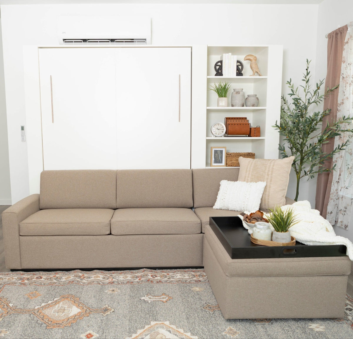 Beige sectional sofa in a living room with a coffee table and decorative items.