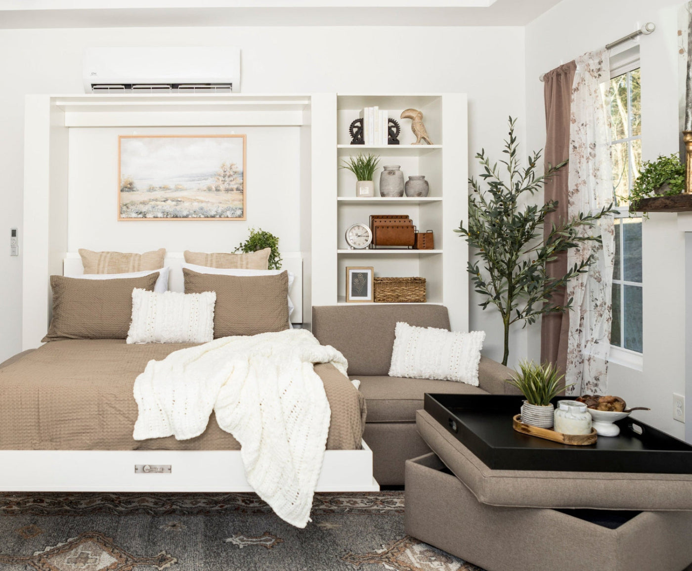 Modern bedroom with a bed, sofa, and decorative elements.