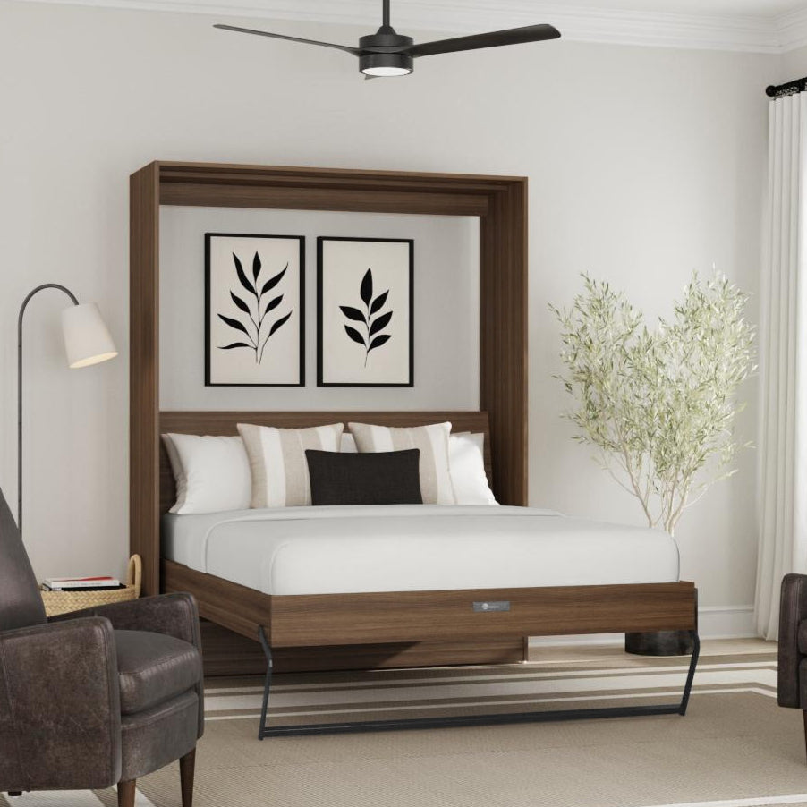 Wooden murphy bed in a modern bedroom with two armchairs and a lamp.
