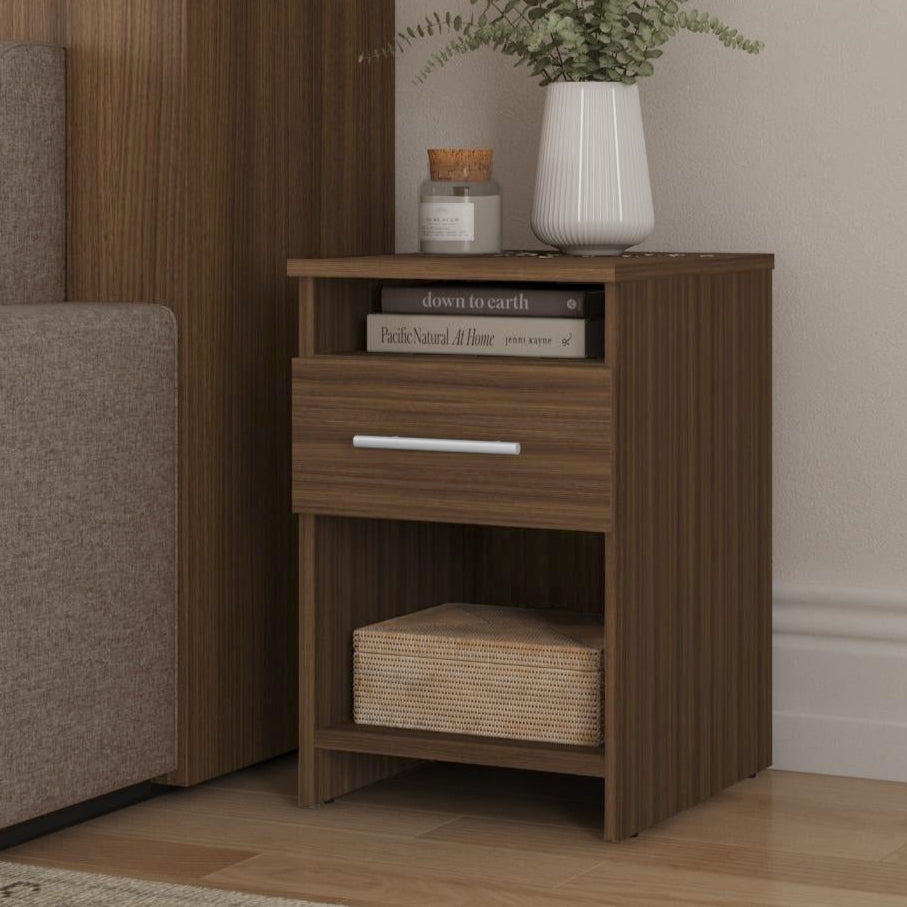 Wooden nightstand with a drawer and open shelf, decorated with books and a vase, in a room setting.