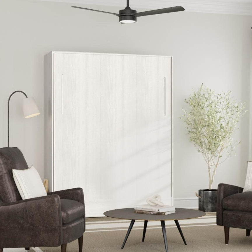 Modern living room with two brown armchairs, a coffee table, and a white wall bed, murphy bed