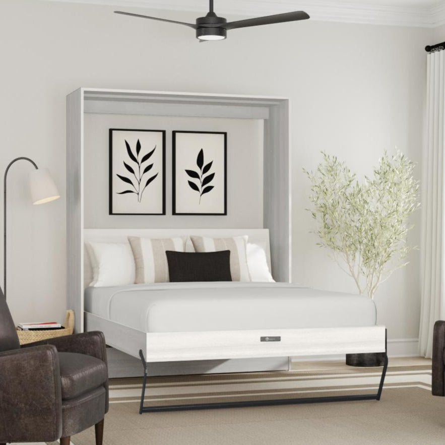 White Murphy bed in a room with two armchairs and a lamp.