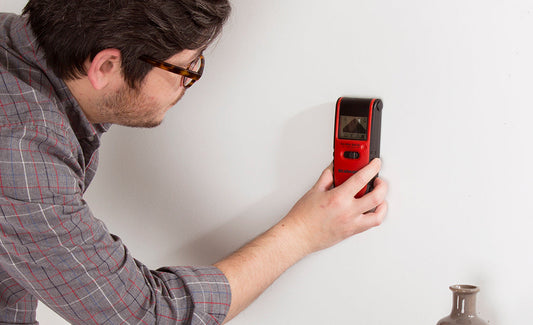 man using a stud finder