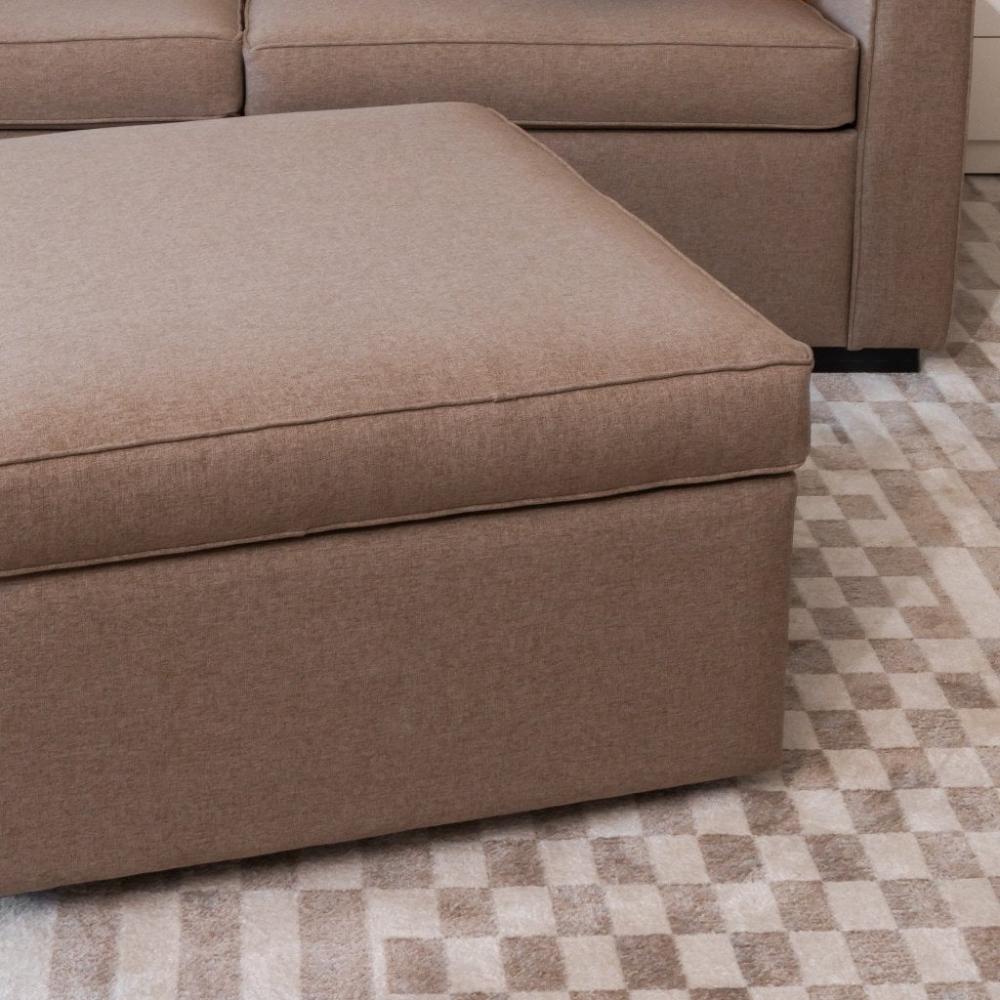 beige ottoman placed in front of sofa