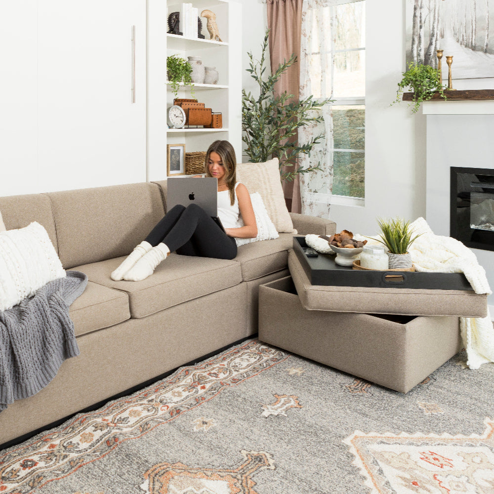 student sitting on the sofa with a laptop