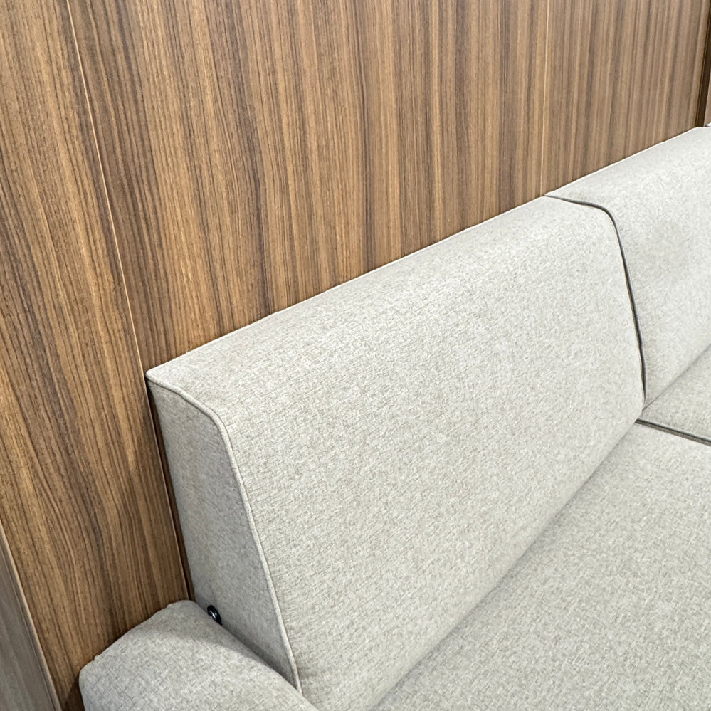 Gray sectional sofa next to a wooden desk