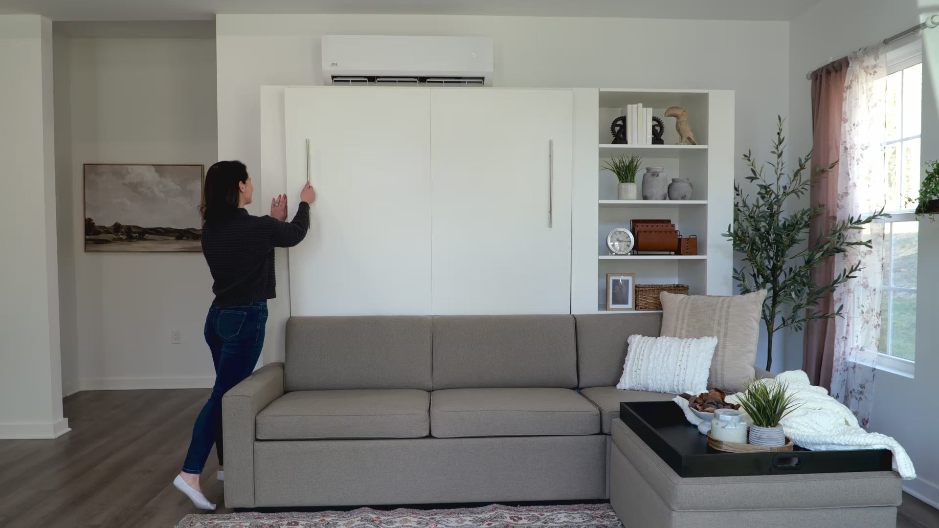 Load video: woman shown opening a muprhy bed in a home office