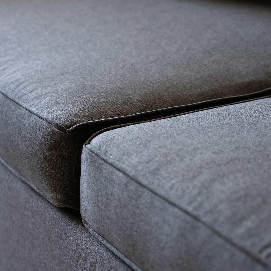 Close up showing piping and comfort details of the sofa for the Wall Bed with Sofa.