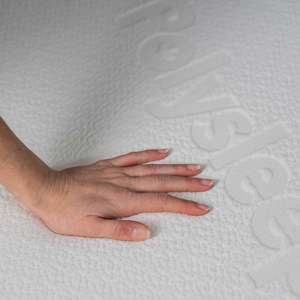 female hand feeling softness of Polysleep 10" mattress