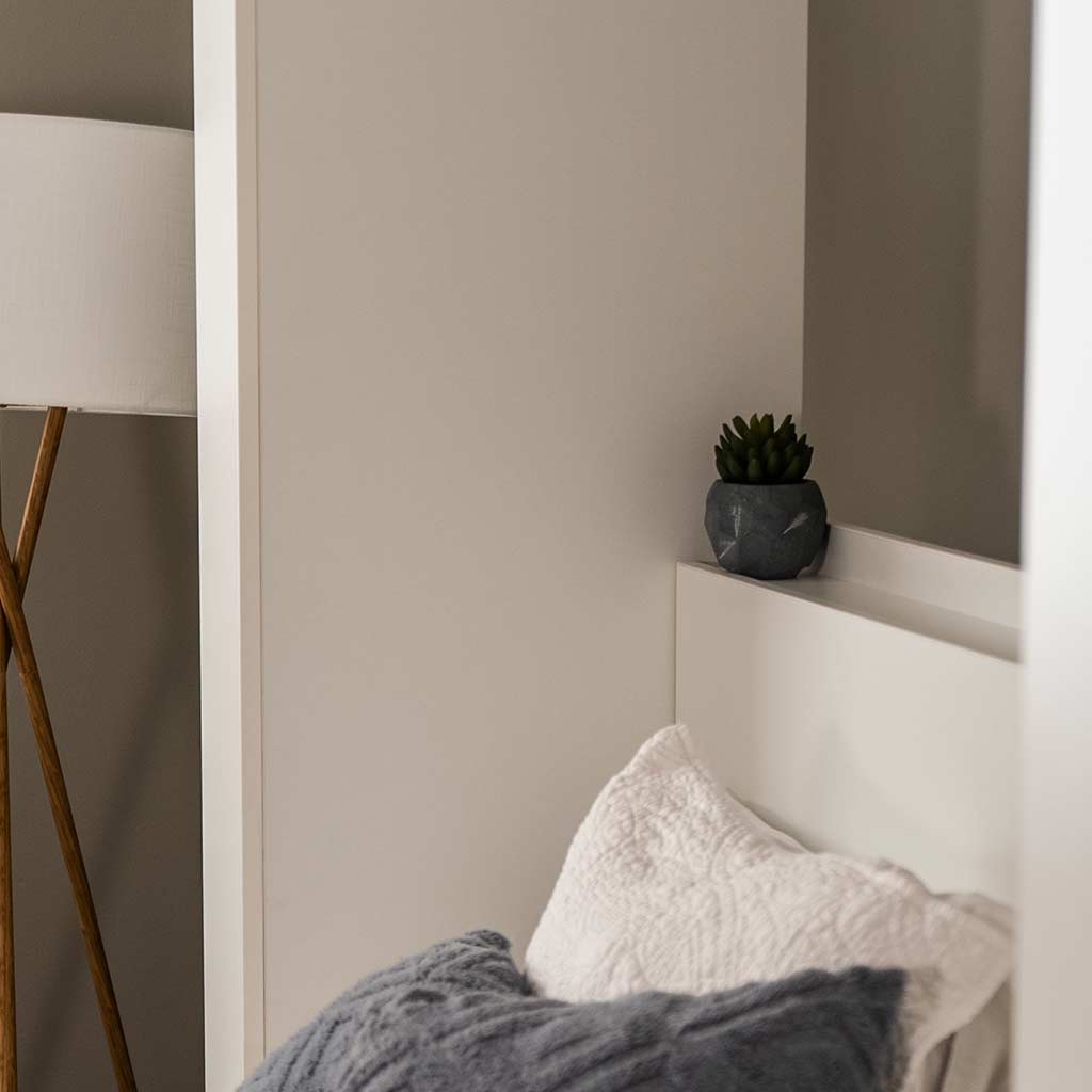 Close up of shelf featuring a fake plant for the Wall Bed with Sofa