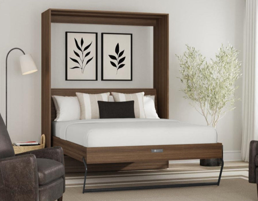 Wooden murphy bed in a modern bedroom with two armchairs and a lamp.