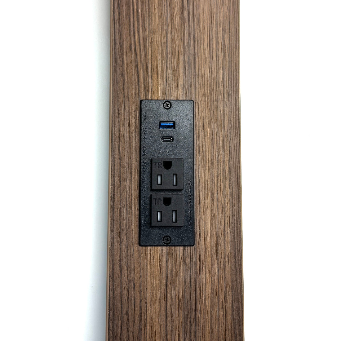 Wooden panel with a built-in electrical outlet and USB ports on a white background